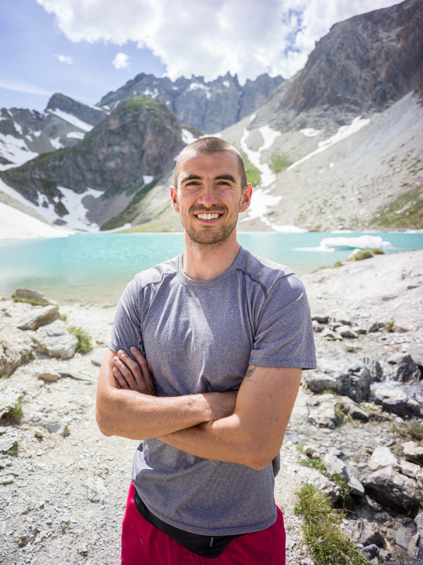 Emmet Trant, founder of Nua Retreats, by an alpine lake near Montgenèvre